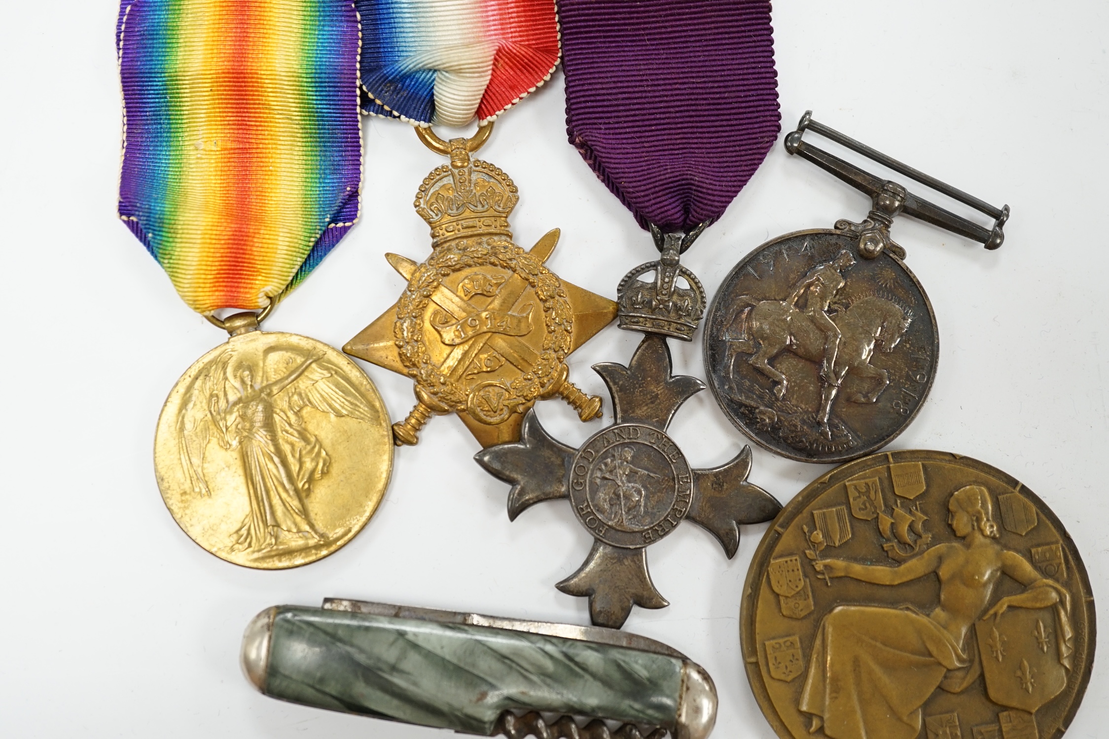 A First World War medal group awarded to Pte. G. Legh-Jones 1/28 London Regiment, comprising; an OBE with First War trio, together with a French Line ‘Ile de France’ commemorative medallion and two penknives. Condition -